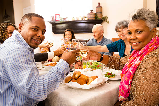 family-friends-gather-for-dinner-at-senior-womans-home.jpg