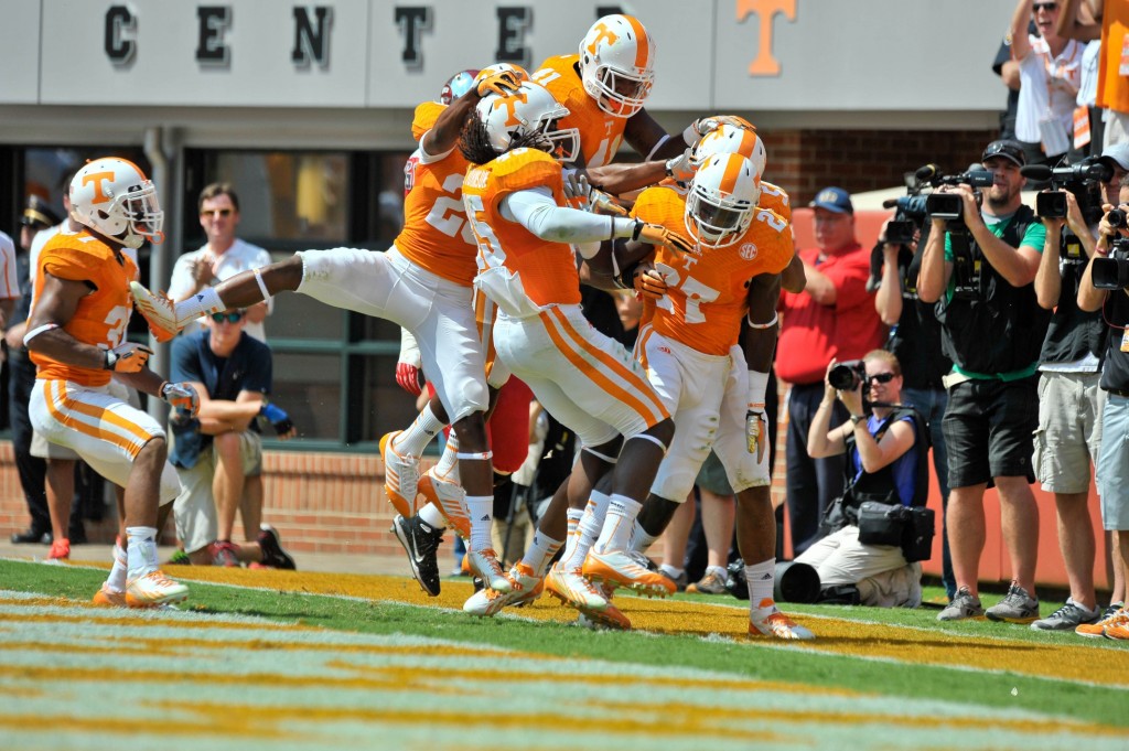 Caption:Sep 7, 2013; Knoxville, TN, USA; Tennessee Volunteers defensive back Justin Coleman (27) celebrates scoring a touchdown on an interception against Western Kentucky Hilltoppers quarterback Brandon Doughty (12) (not pictured) with teammate Tennessee linebacker A.J. Johnson (45) and Tennessee linebacker Dontavis Sapp (41) during the first half at Neyland Stadium. Mandatory Credit: Jim Brown-USA TODAY Sports