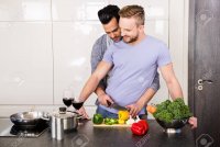 52104119-smiling-gay-couple-preparing-food-in-the-kitchen.jpg