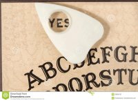 ouija-board-planchette-pointing-to-yes-29095131.jpg