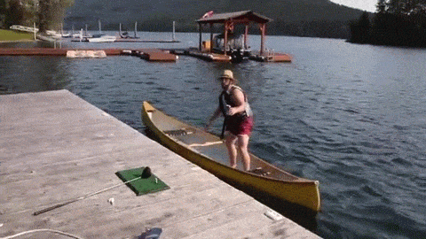 Naked guy takes out friend in canoe with devastating tackle.gif