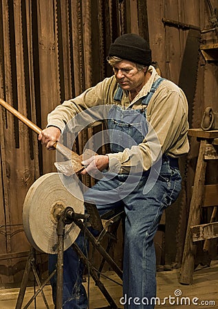 man-sharpening-an-axe-on-a-grinding-stone-thumb16403850.jpg