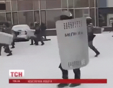 riot-police-cop-smashes-camera-news-13910426703.gif