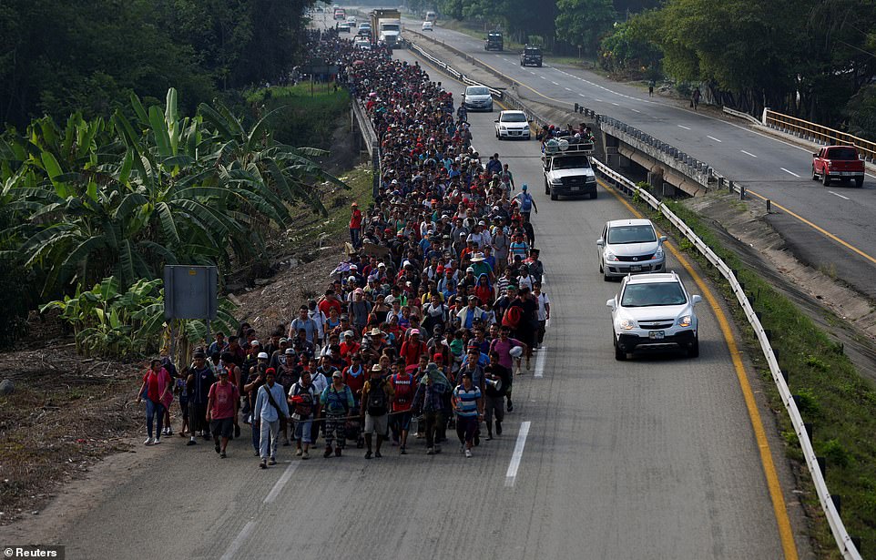 12452362-6937855-Hundreds_of_migrants_were_spotted_walking_along_a_highway_in_the-a-20_1555620973172.jpg