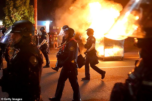 37753860-9125107-Portland_endured_more_than_100_nights_of_rioting_during_last_sum-a-9_1610094602742.jpg