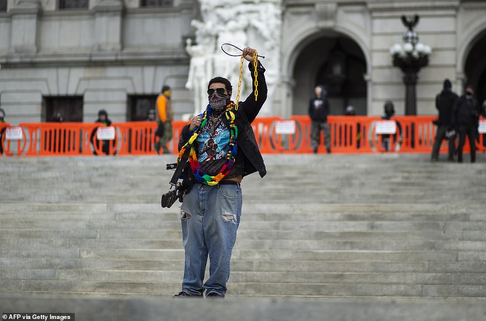38123266-9156435-A_protester_carries_a_crossbow_outside_the_capitol_in_Harrisburg-a-147_1610920471708.jpg
