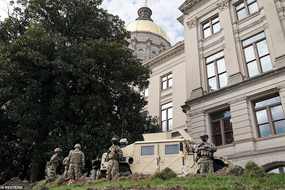 38124448-9156435-Members_of_the_Georgia_National_Guard_take_positions_outside_the-a-151_1610920472082.jpg