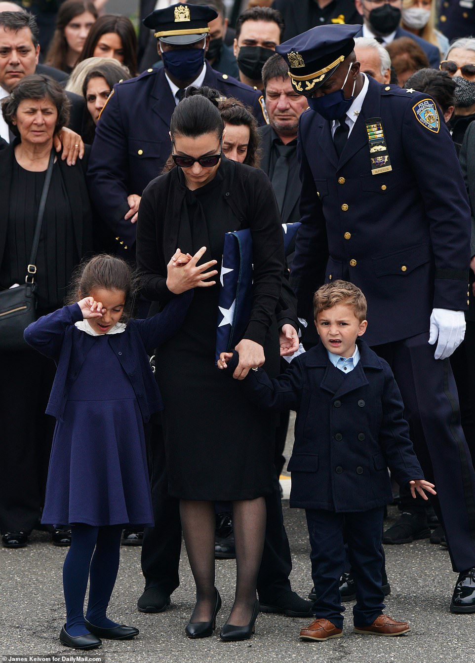42569544-9542311-The_officer_s_wife_and_two_children_gathered_for_the_service_His-m-52_1620156176569.jpg