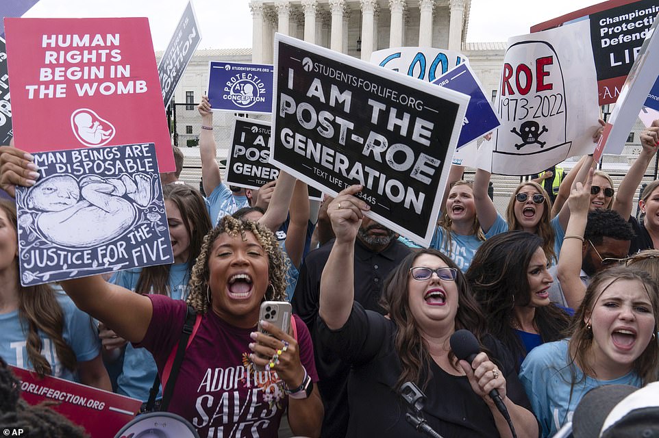 59481355-10950553-Pro_life_activists_cheer_outside_the_Supreme_Court_Friday_mornin-a-37_1656102426495.jpg