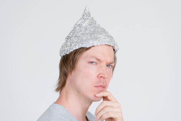 portrait-young-handsome-man-wearing-tin-foil-hat-as-conspiracy-theory-concept-white_251136-79096.jpg