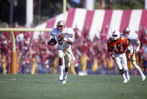 college-football-florida-state-deion-sanders-in-action-returning-vs-picture-id109701930