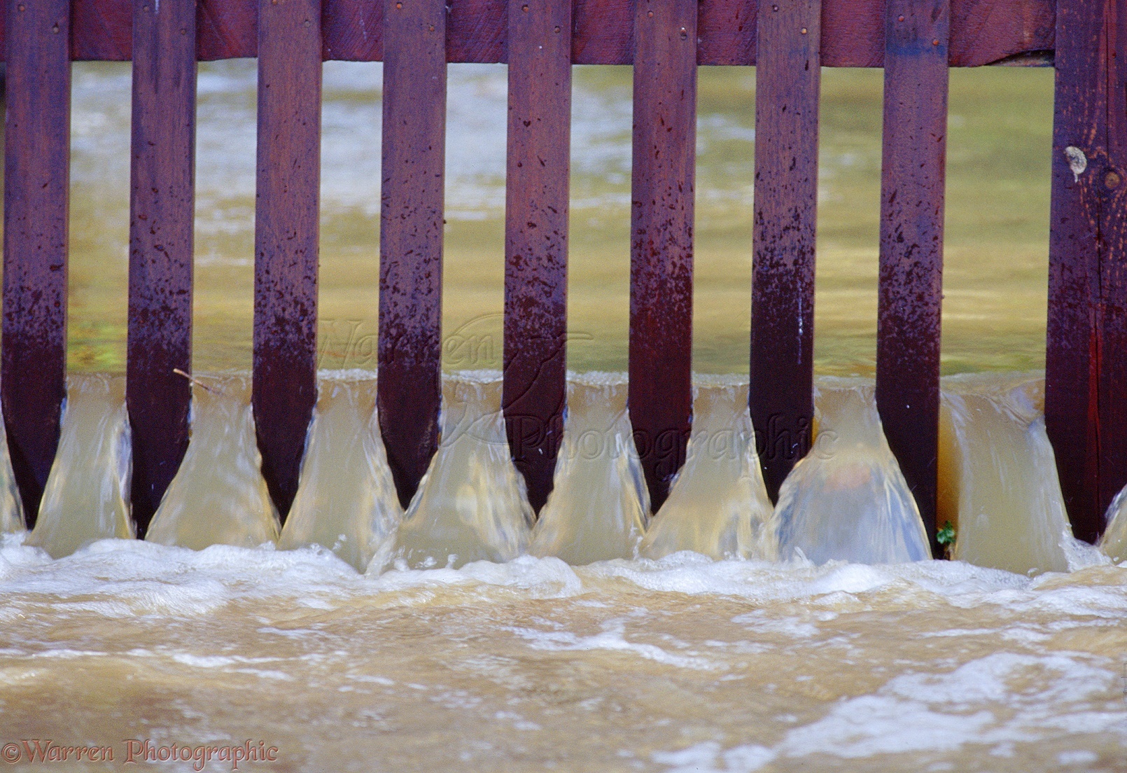 01785-Flood-water-pouring-through-a-fence.jpg